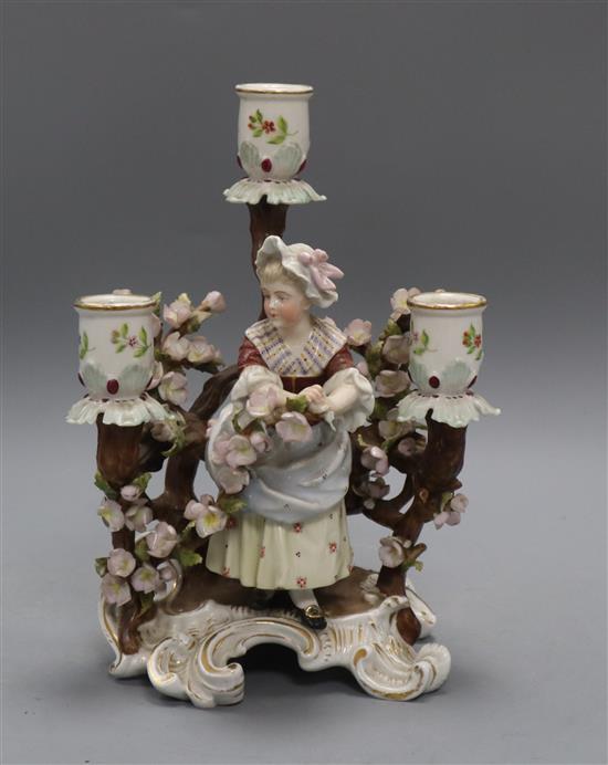 A Sitzendorf porcelain three branch candelabra, decorated with flowers surrounding a girl height 24cm